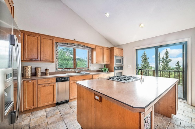 kitchen with a kitchen island, stainless steel appliances, sink, and high vaulted ceiling