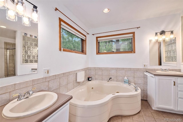 bathroom with vanity, tile walls, shower with separate bathtub, and tile patterned flooring