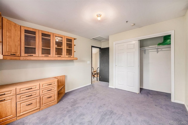 unfurnished bedroom featuring carpet and a closet