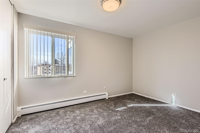 carpeted spare room with a baseboard radiator and baseboards