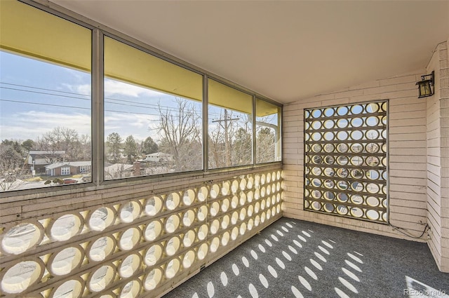 unfurnished sunroom with lofted ceiling