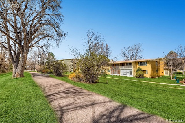 exterior space featuring stucco siding and a front yard