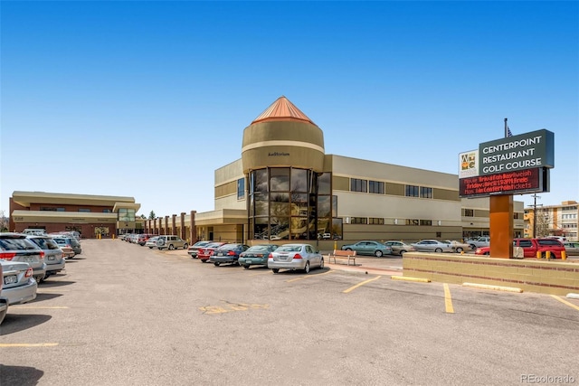 view of building exterior featuring uncovered parking