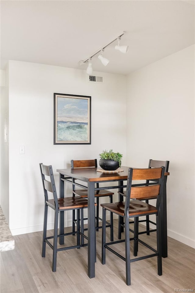 3026 W Prentice Ave Unit H, Littleton, CO 80123 - dining space featuring track lighting and light wood-style floors