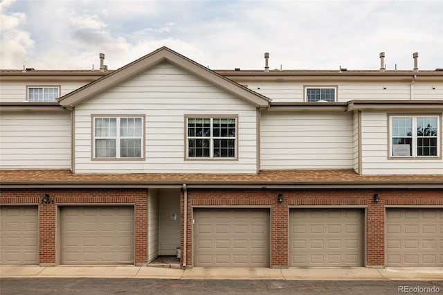 3026 W Prentice Ave Unit H, Littleton, CO 80123 - view of front of home featuring a garage and brick siding