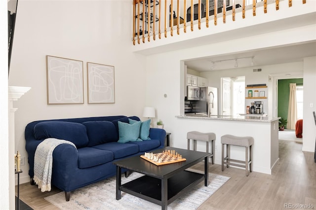 3026 W Prentice Ave Unit H, Littleton, CO 80123 - living room with light wood finished floors and track lighting