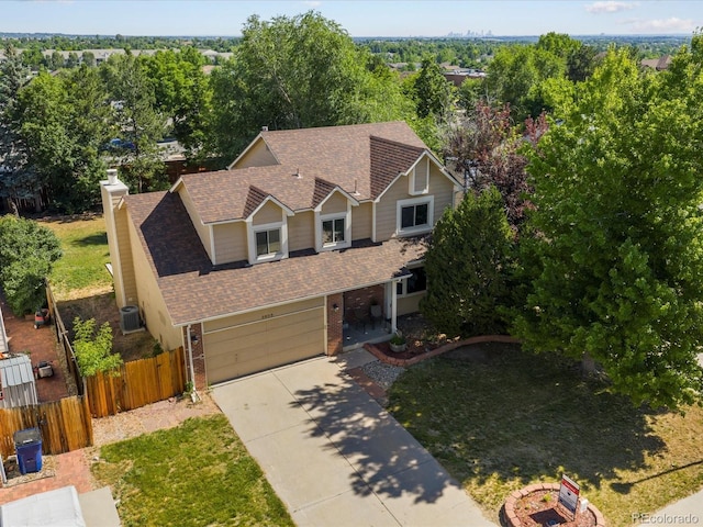 5903 S Ward St, Littleton, CO 80127 - view of front of property featuring brick siding, a shingled roof, driveway, a garage, and a chimney