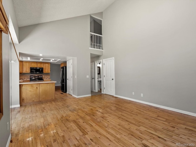 5903 S Ward St, Littleton, CO 80127 - unfurnished living room with light wood finished floors and high vaulted ceiling