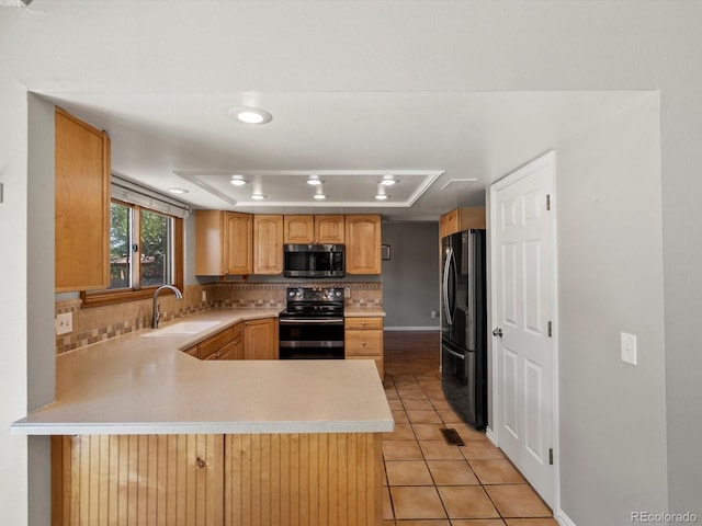 5903 S Ward St, Littleton, CO 80127 - kitchen with electric stove, stainless steel microwave, freestanding refrigerator, tasteful backsplash, and light countertops