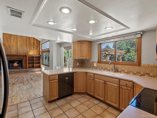 5903 S Ward St, Littleton, CO 80127 - kitchen featuring dishwashing machine, a textured ceiling, open floor plan, backsplash, and a peninsula