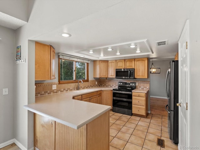 5903 S Ward St, Littleton, CO 80127 - kitchen featuring stainless steel appliances, a peninsula, light countertops, recessed lighting, and backsplash