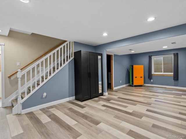 5903 S Ward St, Littleton, CO 80127 - unfurnished living room featuring stairway, light wood-type flooring, and recessed lighting
