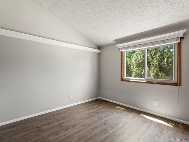 5903 S Ward St, Littleton, CO 80127 - empty room featuring a textured ceiling, wood finished floors, and vaulted ceiling