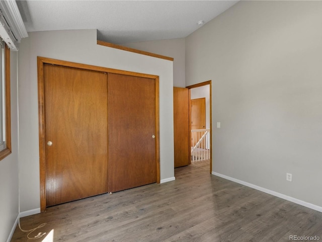 5903 S Ward St, Littleton, CO 80127 - unfurnished bedroom with lofted ceiling, wood finished floors, and a closet