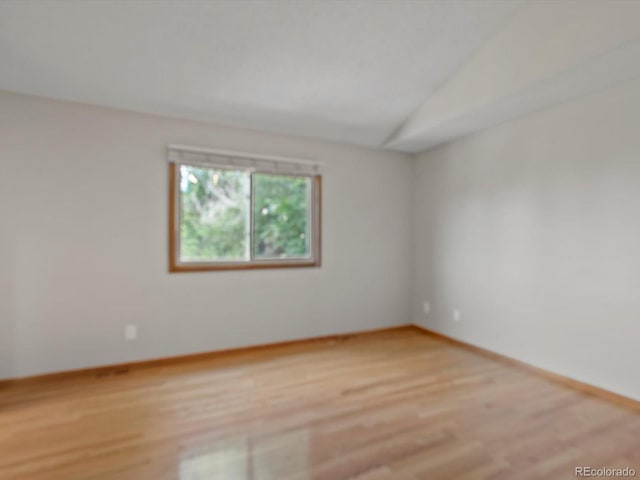 5903 S Ward St, Littleton, CO 80127 - empty room with light wood finished floors and vaulted ceiling