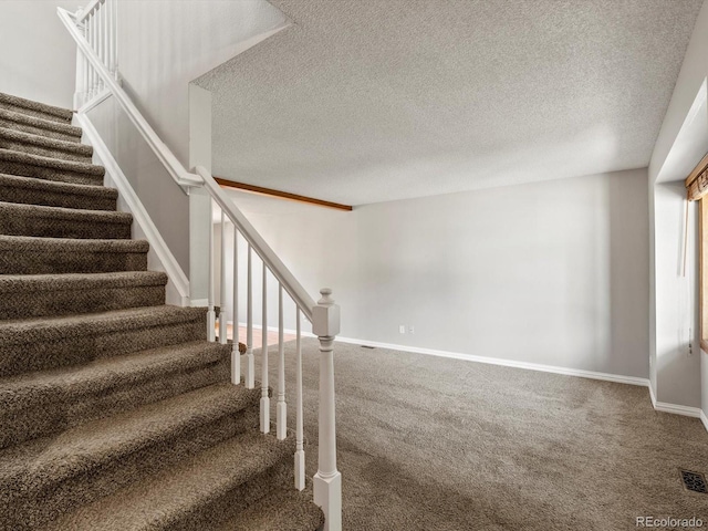 5903 S Ward St, Littleton, CO 80127 - stairway featuring carpet flooring and a textured ceiling