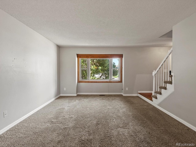 5903 S Ward St, Littleton, CO 80127 - carpeted empty room with a textured ceiling and stairway
