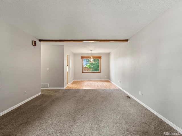 5903 S Ward St, Littleton, CO 80127 - carpeted empty room featuring a textured ceiling and a chandelier