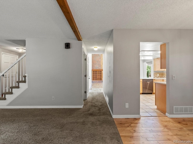 5903 S Ward St, Littleton, CO 80127 - hallway featuring a textured ceiling, light wood-style floors, stairway, and beam ceiling