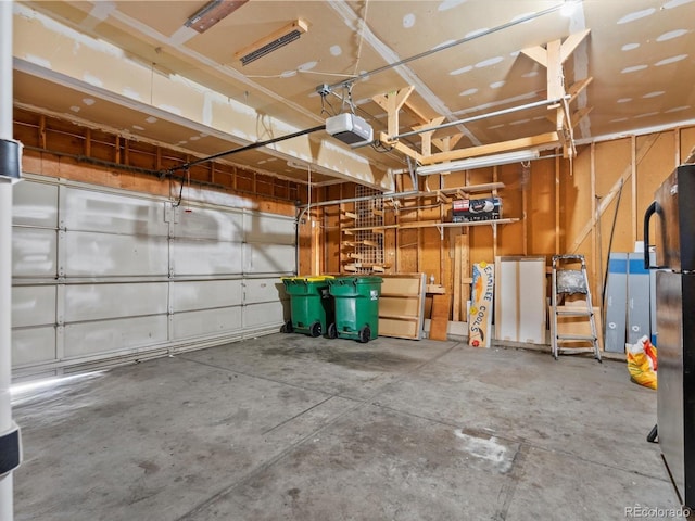 5903 S Ward St, Littleton, CO 80127 - garage with a garage door opener and freestanding refrigerator