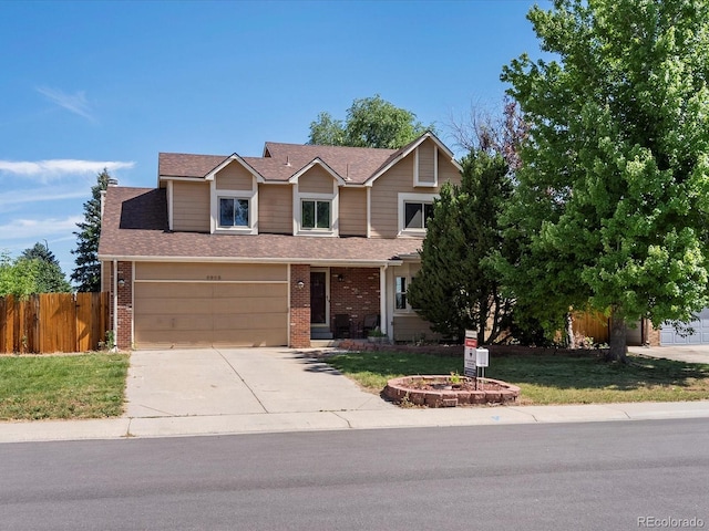 5903 S Ward St, Littleton, CO 80127 - view of front of home featuring brick siding, concrete driveway, and roof with shingles