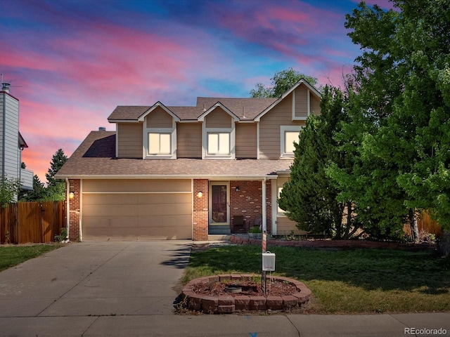 5903 S Ward St, Littleton, CO 80127 - traditional home with concrete driveway, brick siding, and roof with shingles