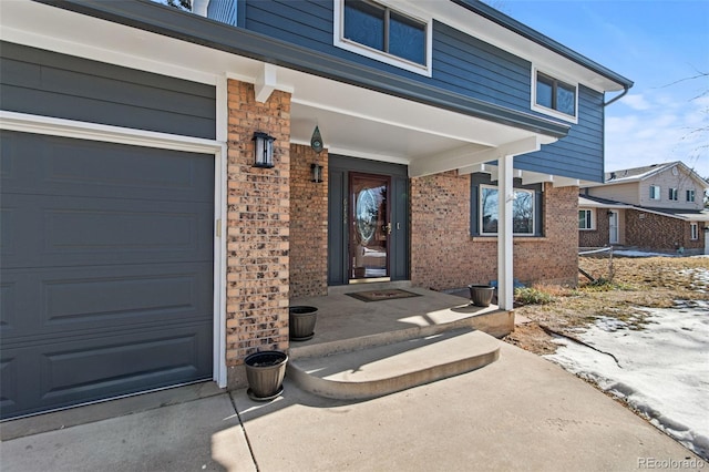 doorway to property featuring a garage and covered porch