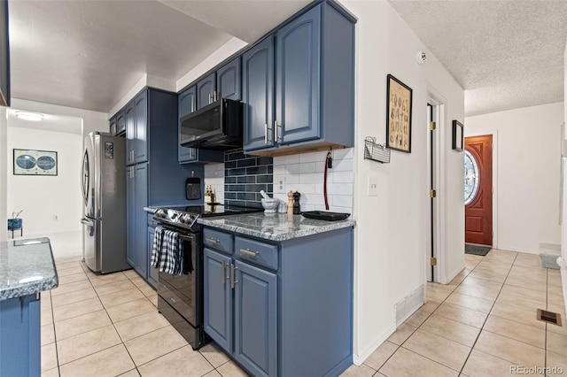 kitchen with light tile patterned flooring, blue cabinets, tasteful backsplash, and black appliances