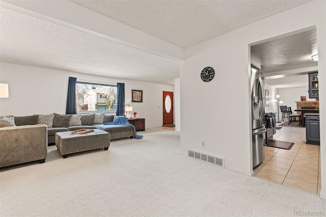 carpeted living room featuring a textured ceiling