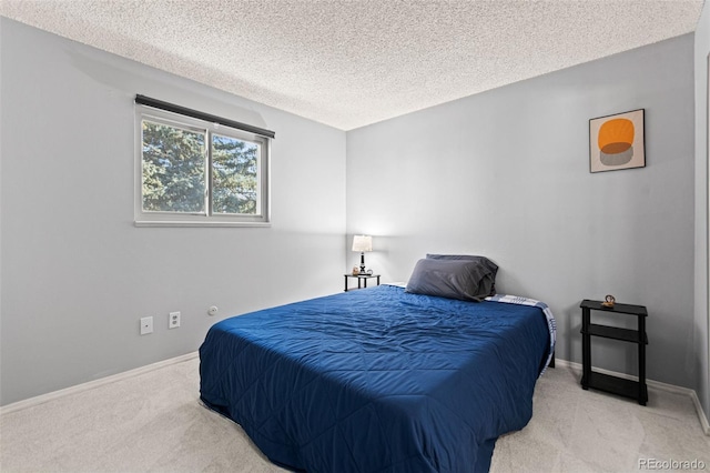 carpeted bedroom featuring a textured ceiling