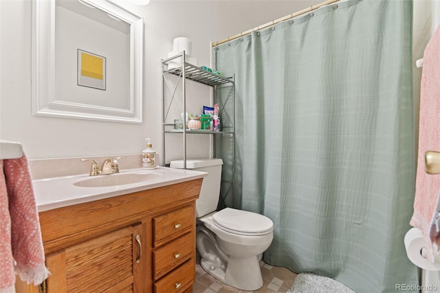 bathroom with vanity, tile patterned floors, and toilet