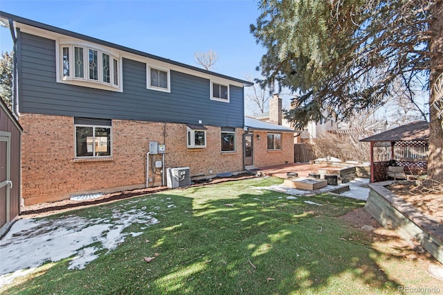 rear view of property with a gazebo, a yard, cooling unit, and a patio area