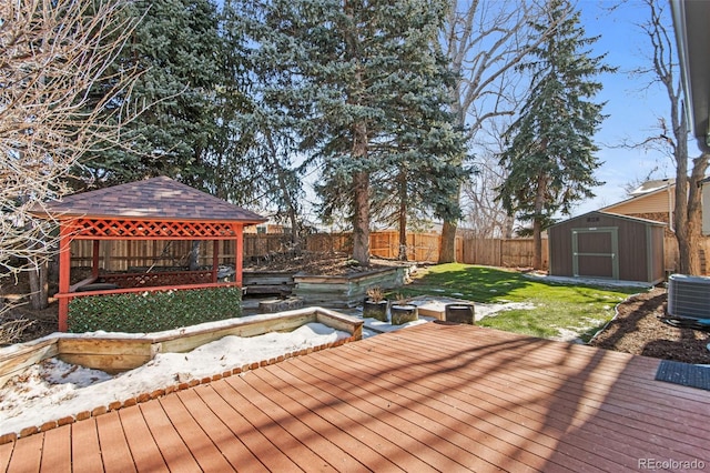 wooden terrace featuring a gazebo, a yard, a storage unit, and cooling unit