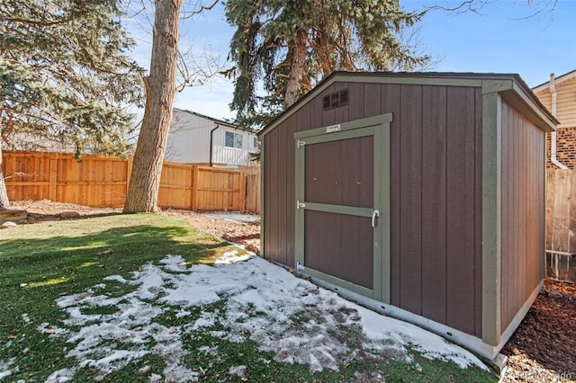 snow covered structure with a yard