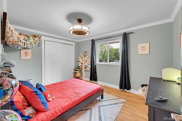 6015 S Milwaukee Way, Centennial, CO 80121 - bedroom with crown molding, wood finished floors, and a closet