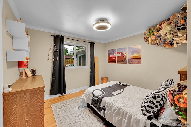 6015 S Milwaukee Way, Centennial, CO 80121 - bedroom with light wood-style flooring and ornamental molding