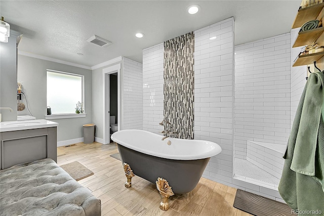 6015 S Milwaukee Way, Centennial, CO 80121 - bathroom with vanity, a freestanding bath, ornamental molding, walk in shower, and wood finished floors