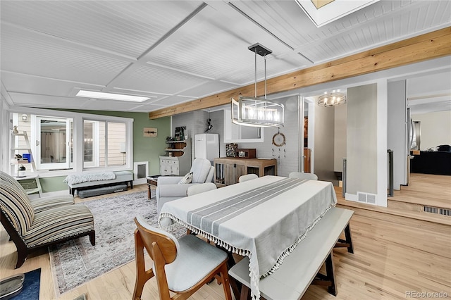 6015 S Milwaukee Way, Centennial, CO 80121 - dining room featuring wood finished floors, a skylight, and a chandelier