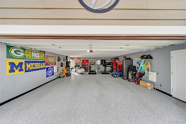 6015 S Milwaukee Way, Centennial, CO 80121 - garage featuring baseboards and a garage door opener