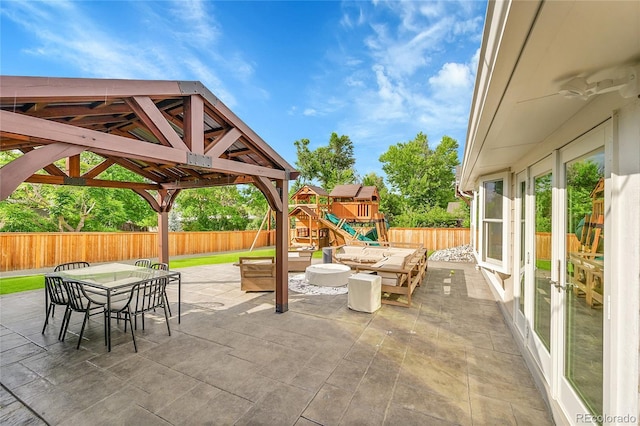 6015 S Milwaukee Way, Centennial, CO 80121 - fenced backyard featuring french doors, outdoor dining area, a patio, a playground, and an outdoor hangout area