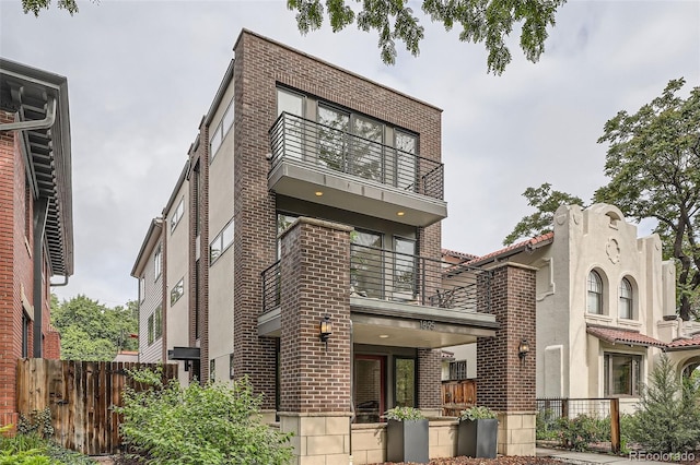 1895 York St, Denver, CO 80206 - view of front of home featuring a balcony, brick siding, and stucco siding