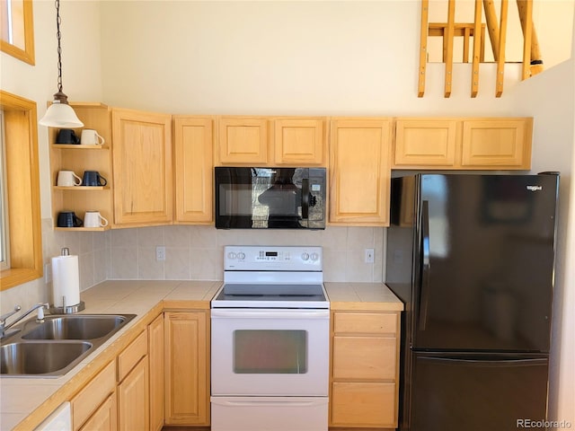 kitchen featuring tile countertops, a sink, light brown cabinetry, black appliances, and tasteful backsplash