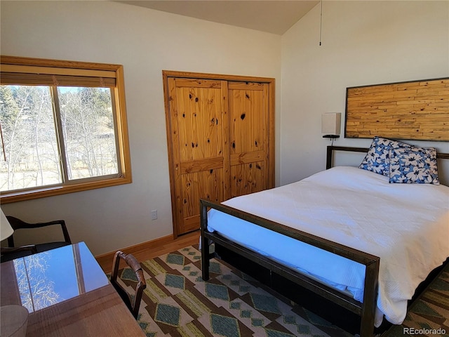 bedroom with baseboards and wood finished floors