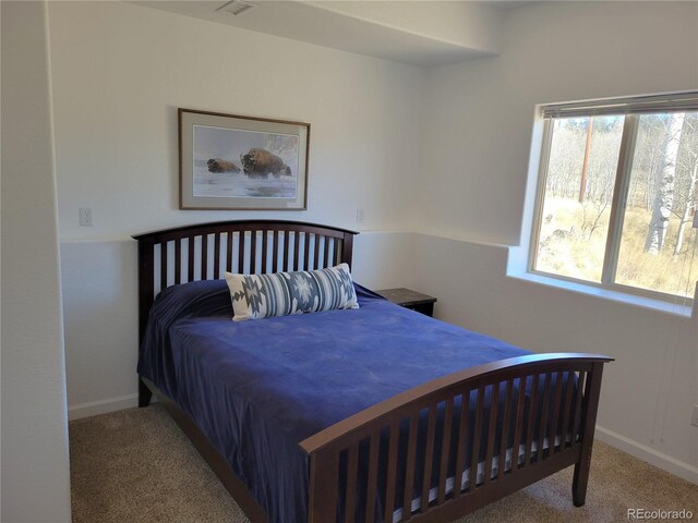 carpeted bedroom featuring baseboards