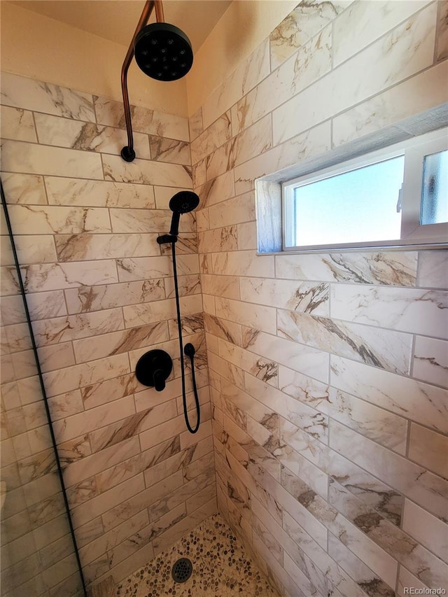 bathroom with a tile shower