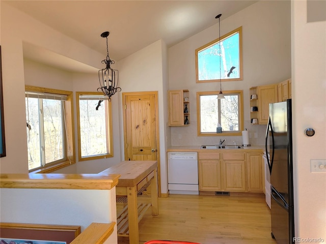 1210 Kiowa St, Como, CO 80432 - kitchen with dishwasher, open shelves, light brown cabinetry, light wood-type flooring, and high vaulted ceiling