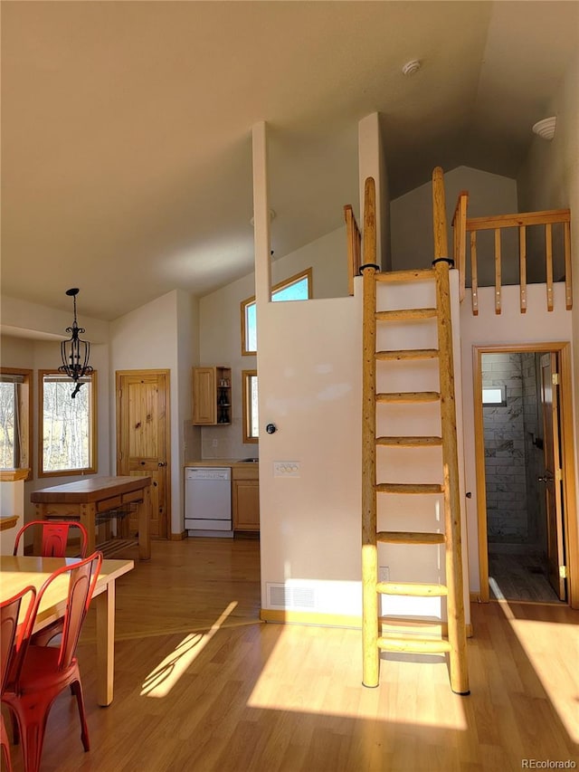 1210 Kiowa St, Como, CO 80432 - dining room with light wood-type flooring, high vaulted ceiling, and a chandelier