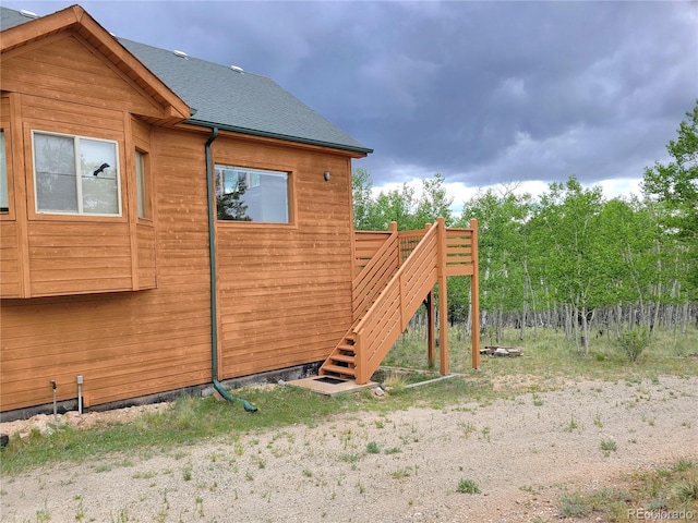 1210 Kiowa St, Como, CO 80432 - view of property exterior with a shingled roof and stairway