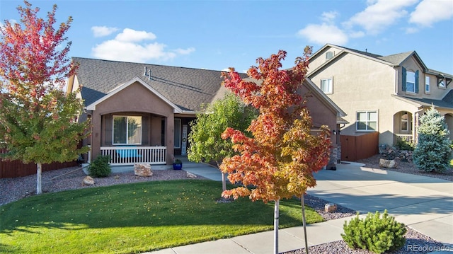 view of property with a front lawn and covered porch