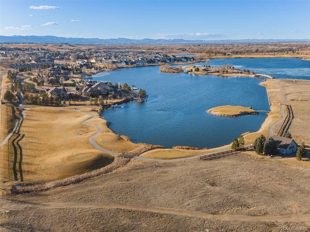 birds eye view of property with a water and mountain view